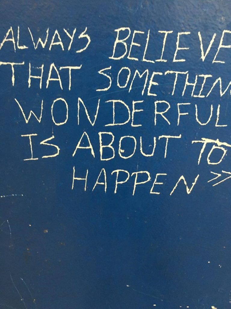 Always believe that something wonderful is about to happen painted on a wall
